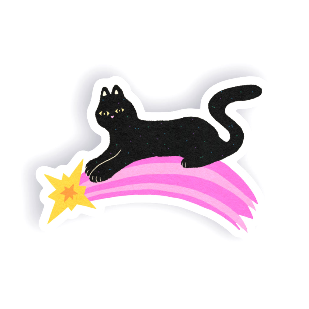 A die-cut sticker featuring a black cat sitting on a pink shooting star, shown on a plain white background.