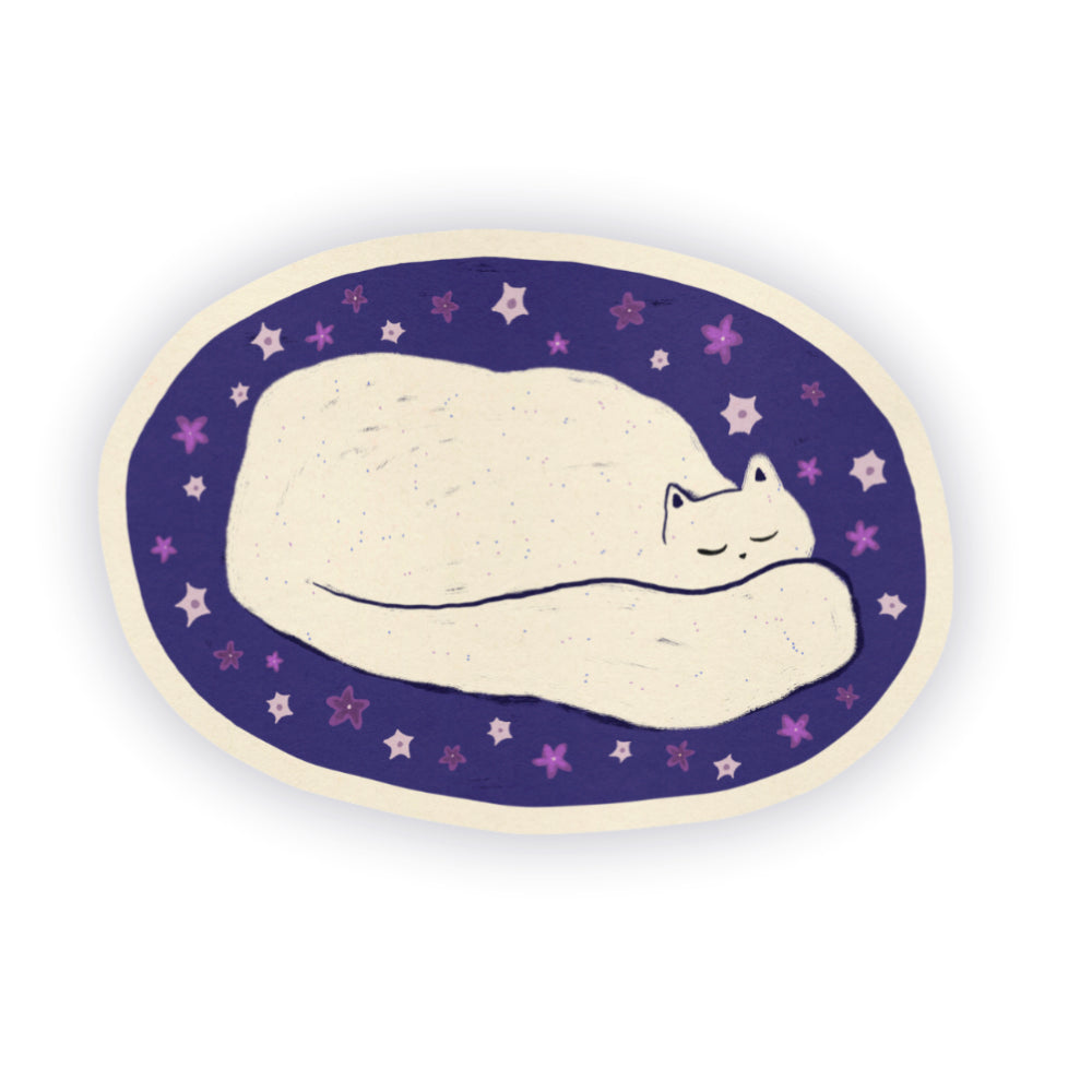 An oval-shaped sticker featuring a hand-drawn illustration of a sleeping white cat on a dark purple background with small flower details.